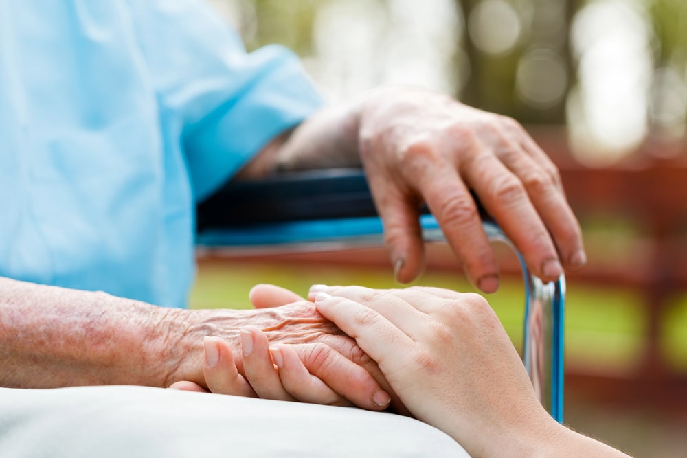 elderly patient with pressure ulcer being treated by nurse
