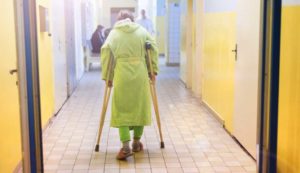 Bedsore Lawyer, NJ- elderly woman walking down hall