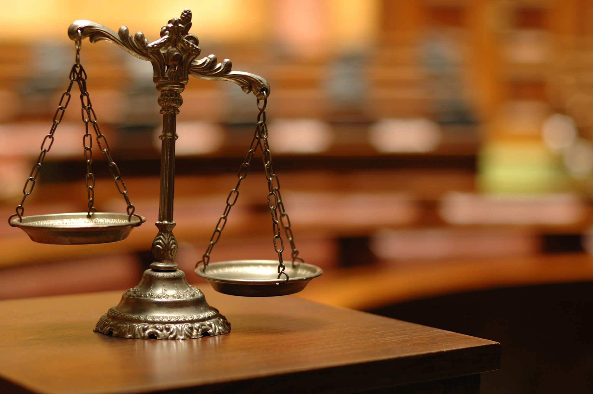 Damages In Wrongful Death Cases - Decorative Scales of Justice in the Courtroom